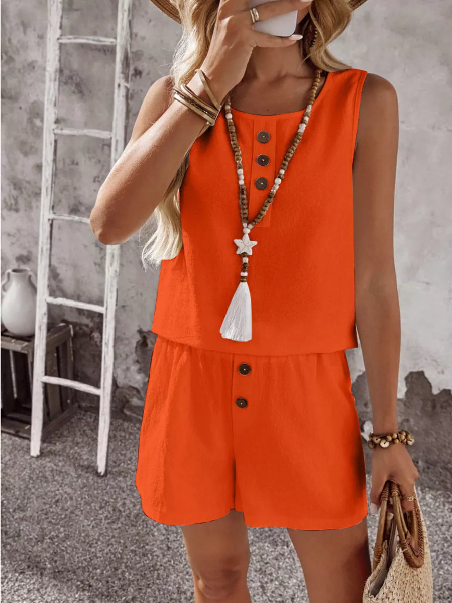 Orange cotton two-piece set with decorative buttons and tassel necklace