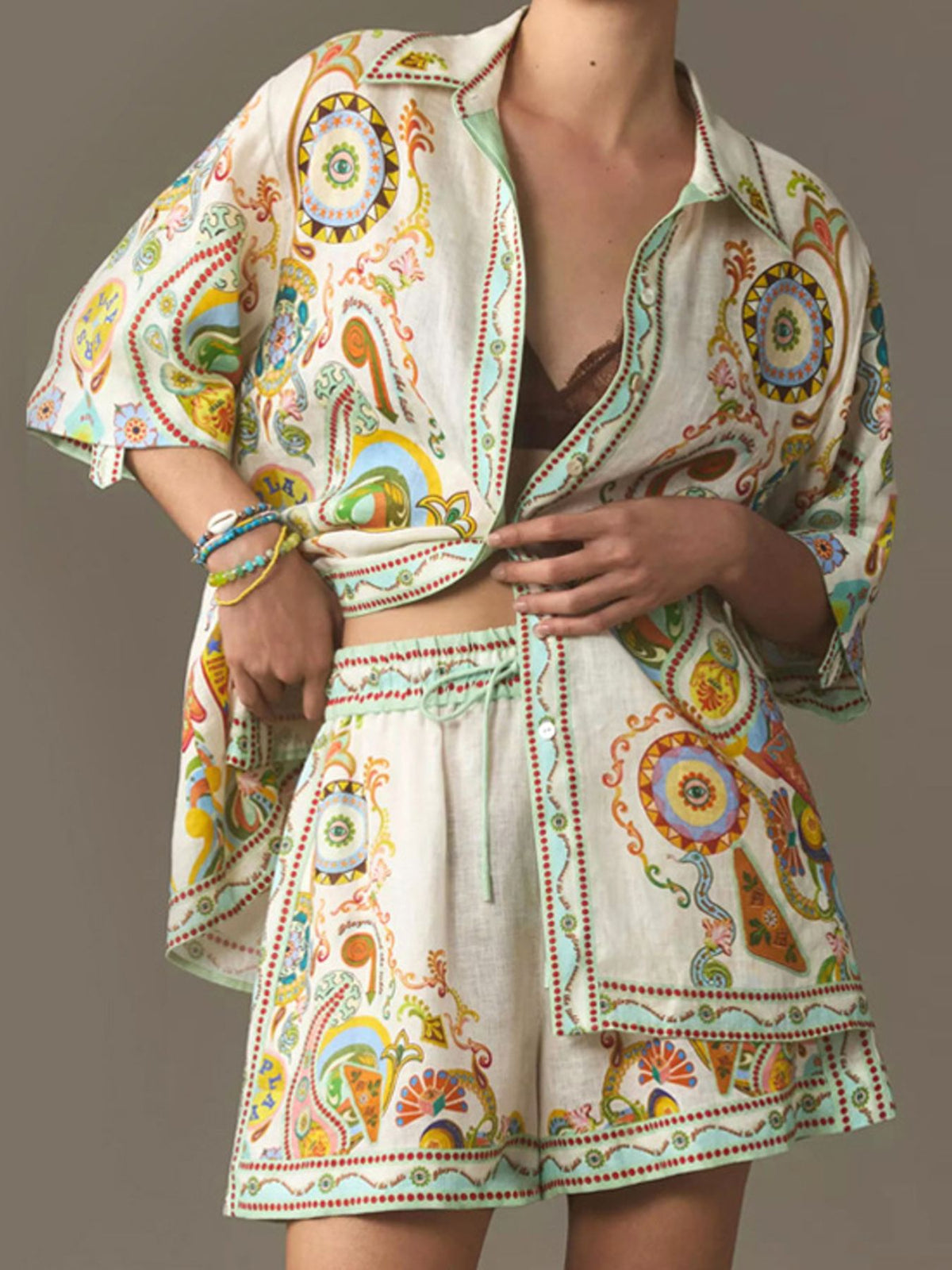 Bohemian print linen two-piece set with buttoned shirt and high-waisted shorts.