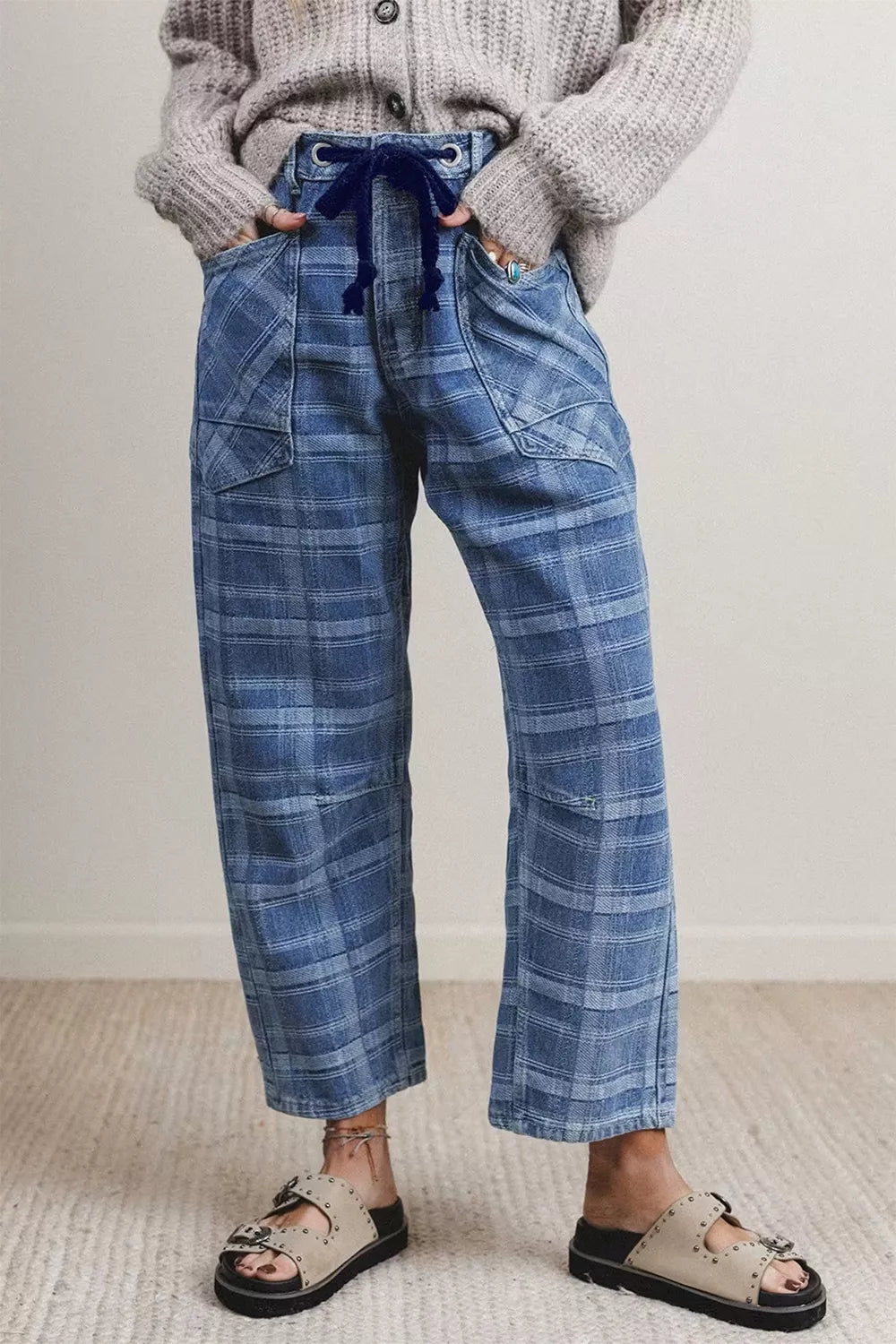 Plaid denim jeans with drawstring waist and grommets in dusty blue cotton.
