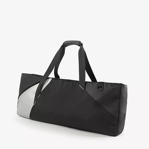 Modern color block travel bag in black with silver accents and dual handles.