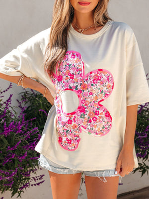 Cream cotton crew neck t-shirt with oversized floral chenille patch detail.