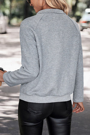 Textured henley sweatshirt in cloudy blue with button detail.