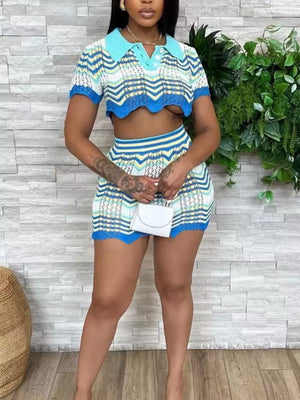 Chevron knit two-piece crop top and skirt set in light blue stripe with polo collar and short sleeves.