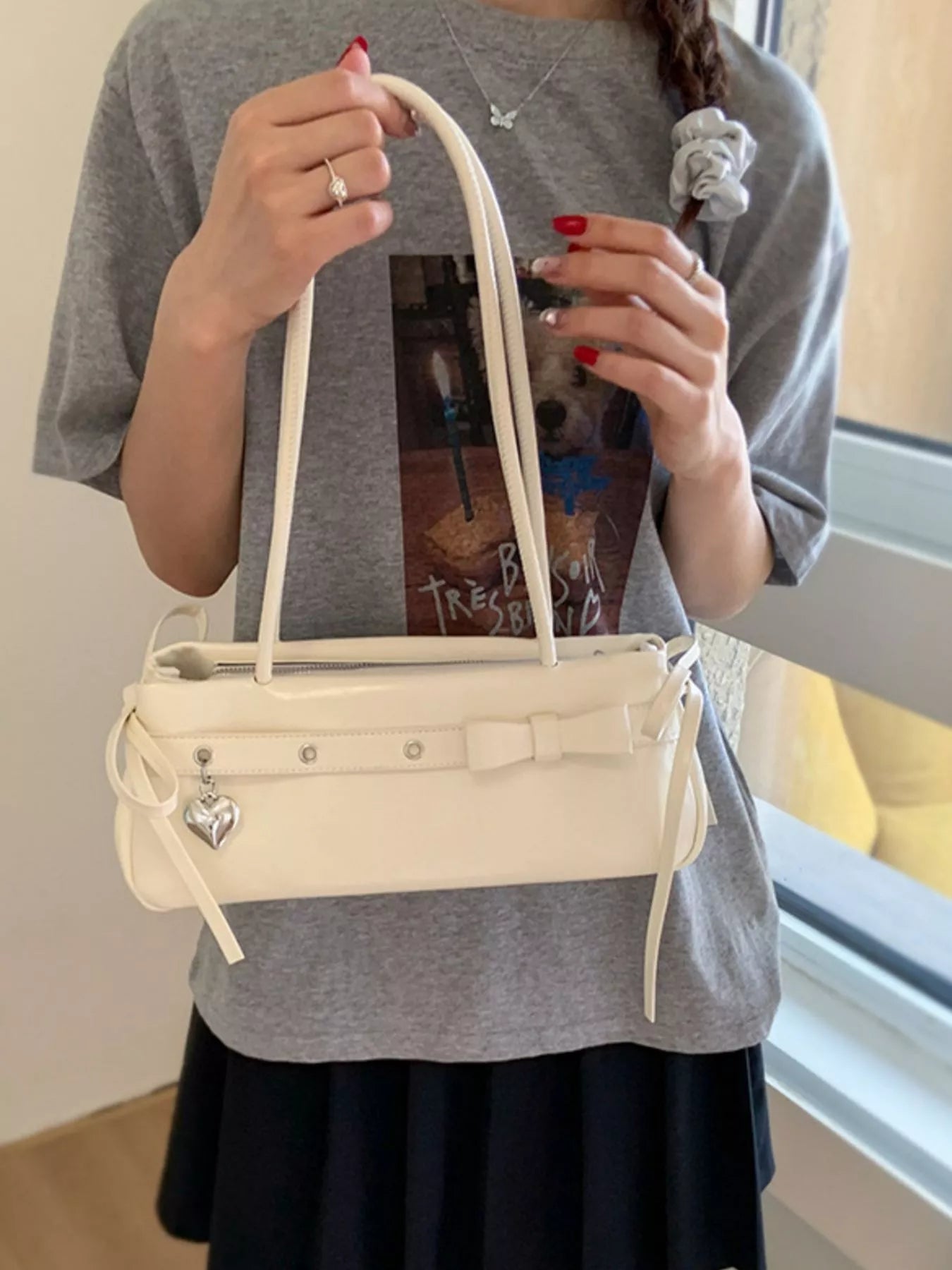 Chic white PU leather shoulder bag with bow detail and heart charm