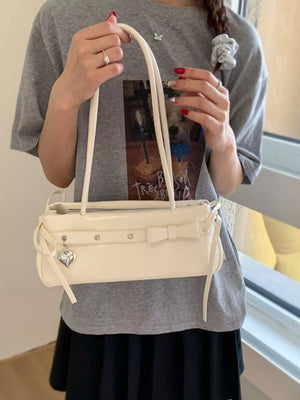 Chic white PU leather shoulder bag with bow detail and heart charm