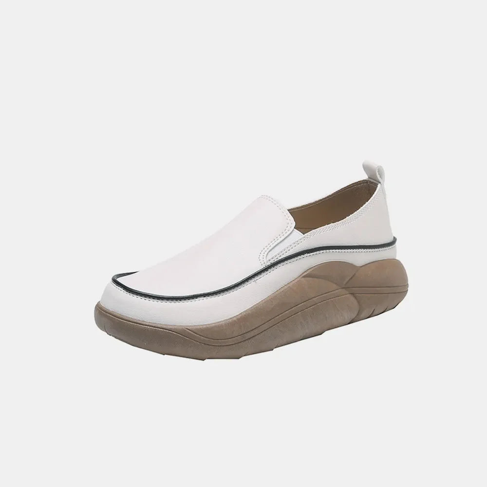 Sculpted platform slip-on sneakers in ivory with a black trim detail and a tan sculpted sole.