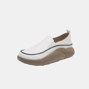 Sculpted platform slip-on sneakers in ivory with a black trim detail and a tan sculpted sole.
