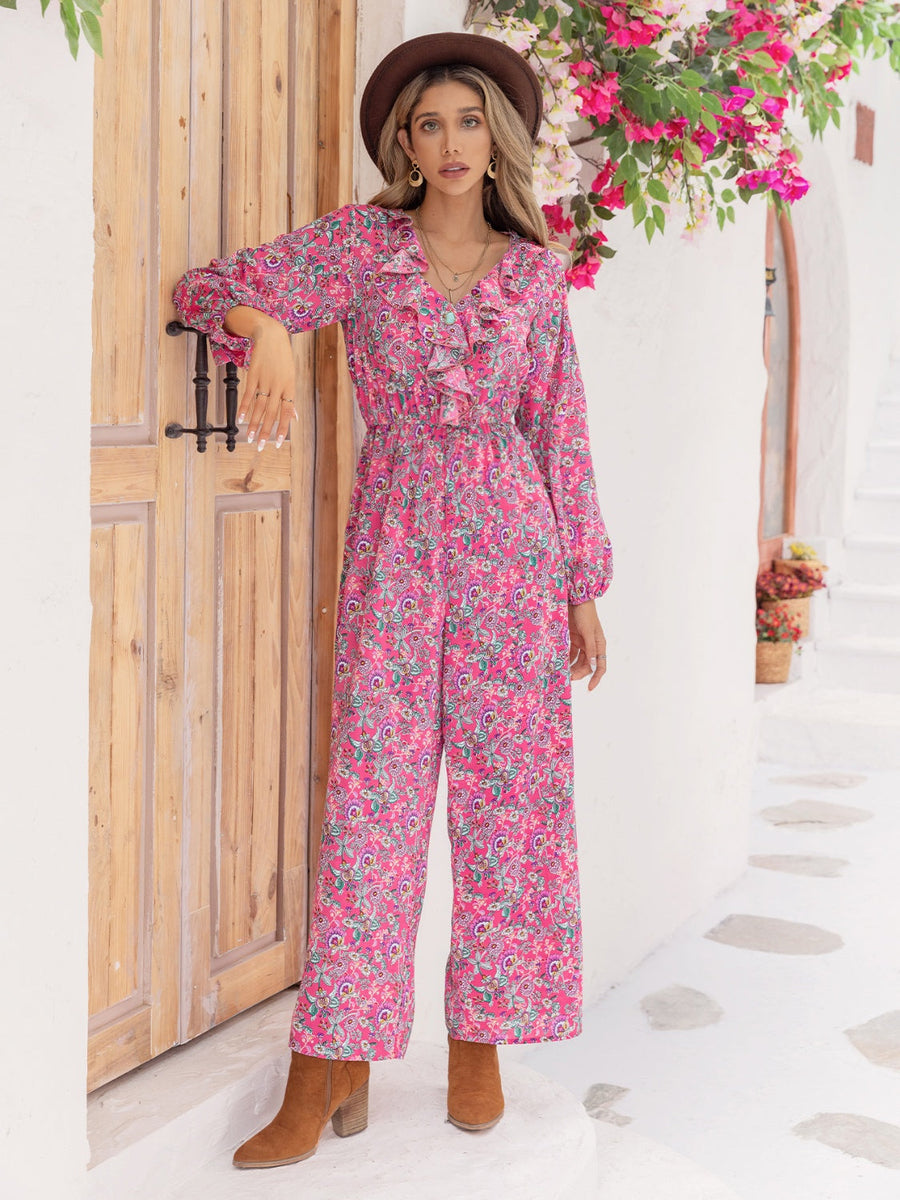 Paisley ruffle front wide leg jumpsuit in hot pink with long sleeves and a v-neck.