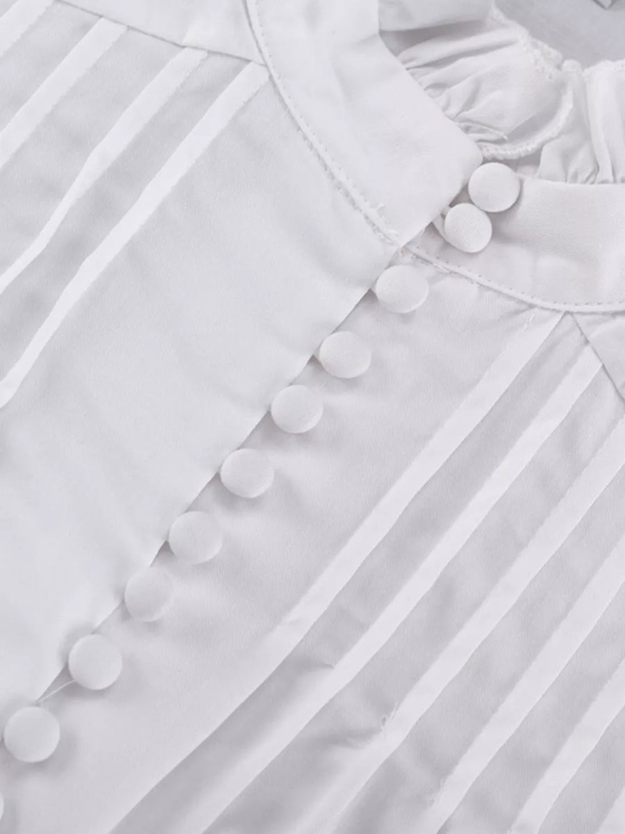 White pintuck blouse with ruffled collar and fabric-covered buttons