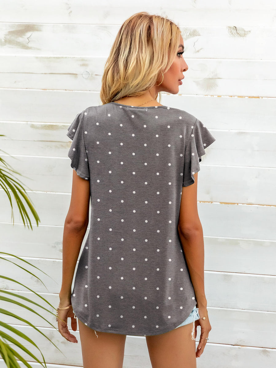 Gray Dawn polka dot tee with ruffled sleeves and a curved hem.