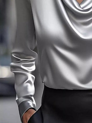 Gray satin cowl neck long-sleeve blouse with draped neckline and ruched sleeve detail.