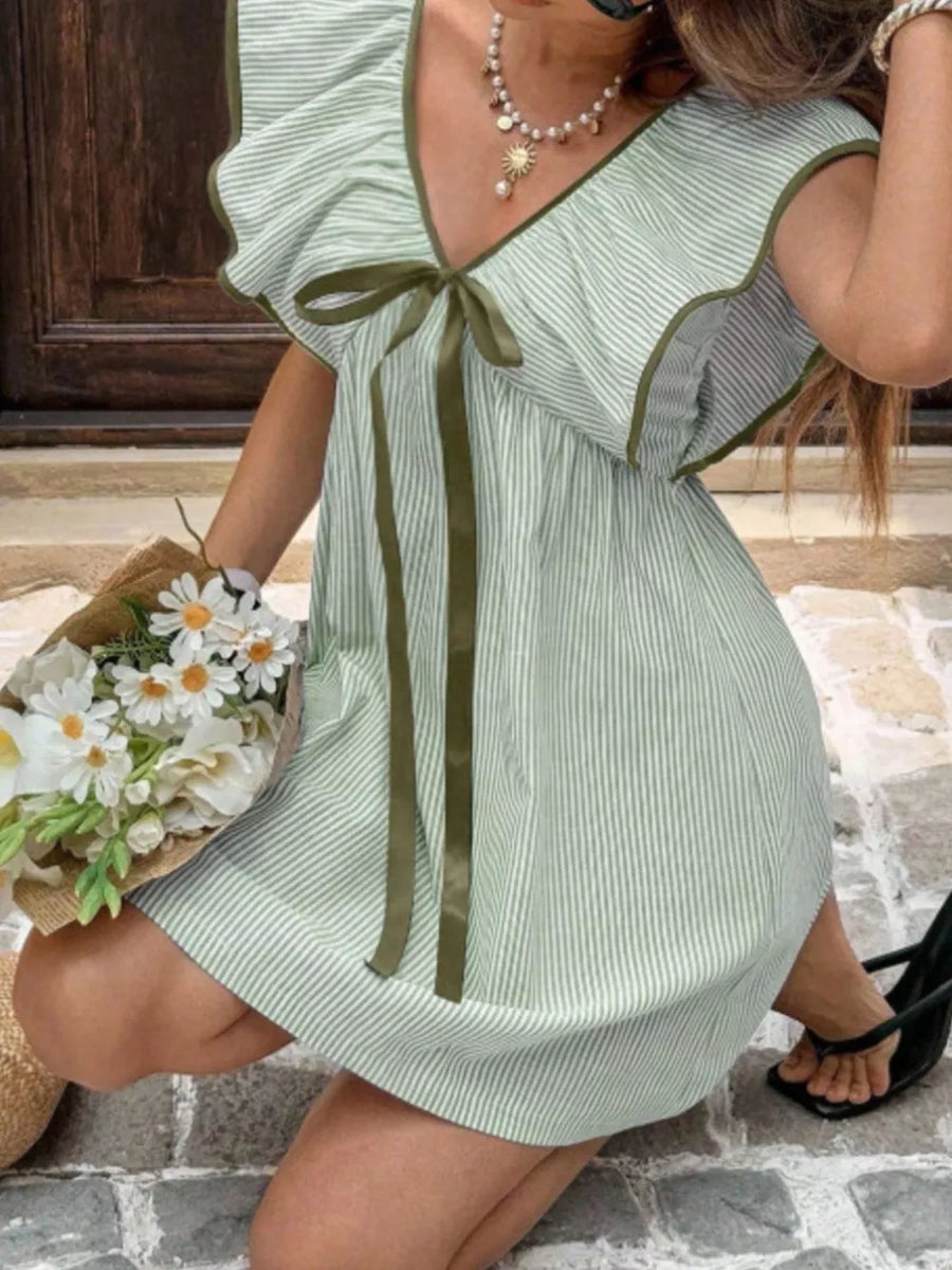 Green striped mini dress with ruffled sleeves, V-neck, and bow detail.