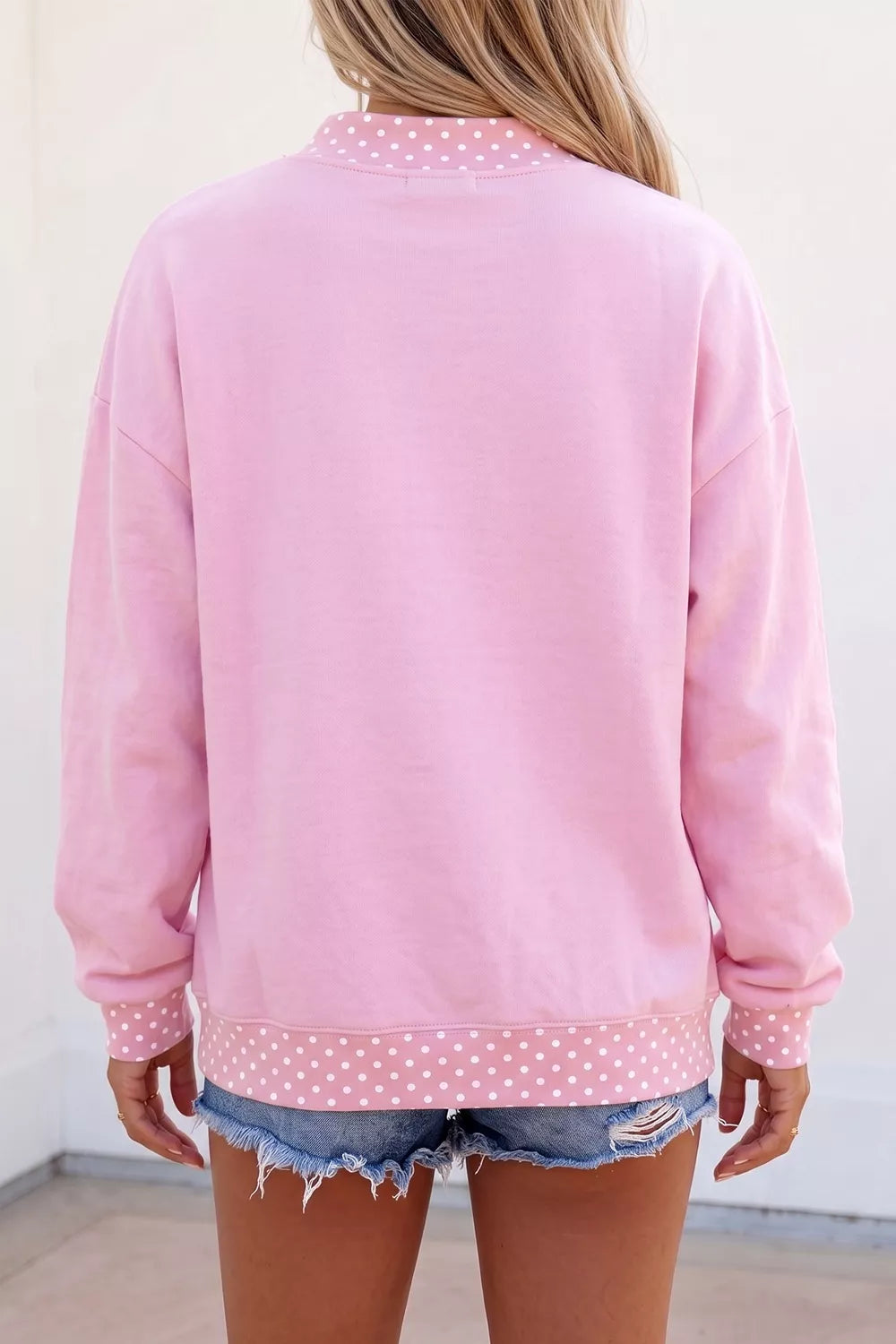 white sweatshirt featuring mock neck and polka dot