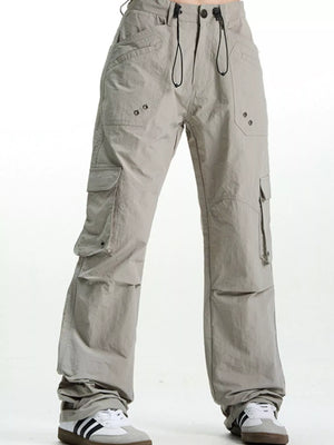 Grey relaxed fit cargo pants with multiple pockets and drawstring waist.