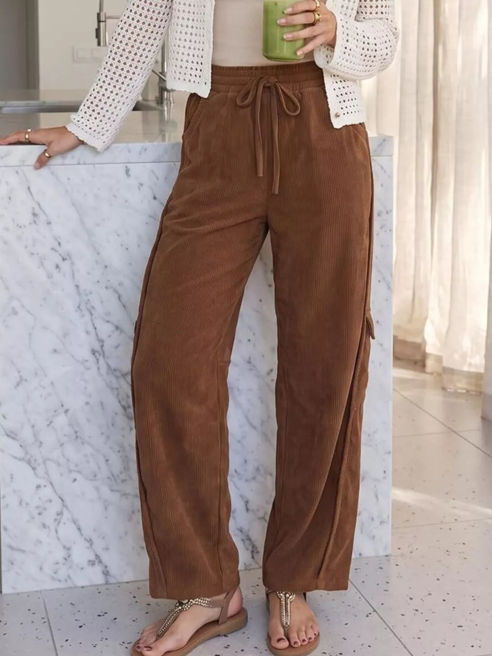 pants in brown featuring drawstring waist and wide-leg fit