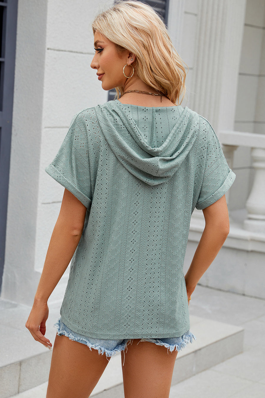 Light Green perforated henley hooded tee with short sleeves and a relaxed fit.