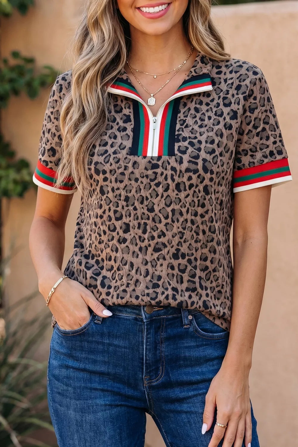 Leopard print half-zip shirt with striped collar and cuffs.