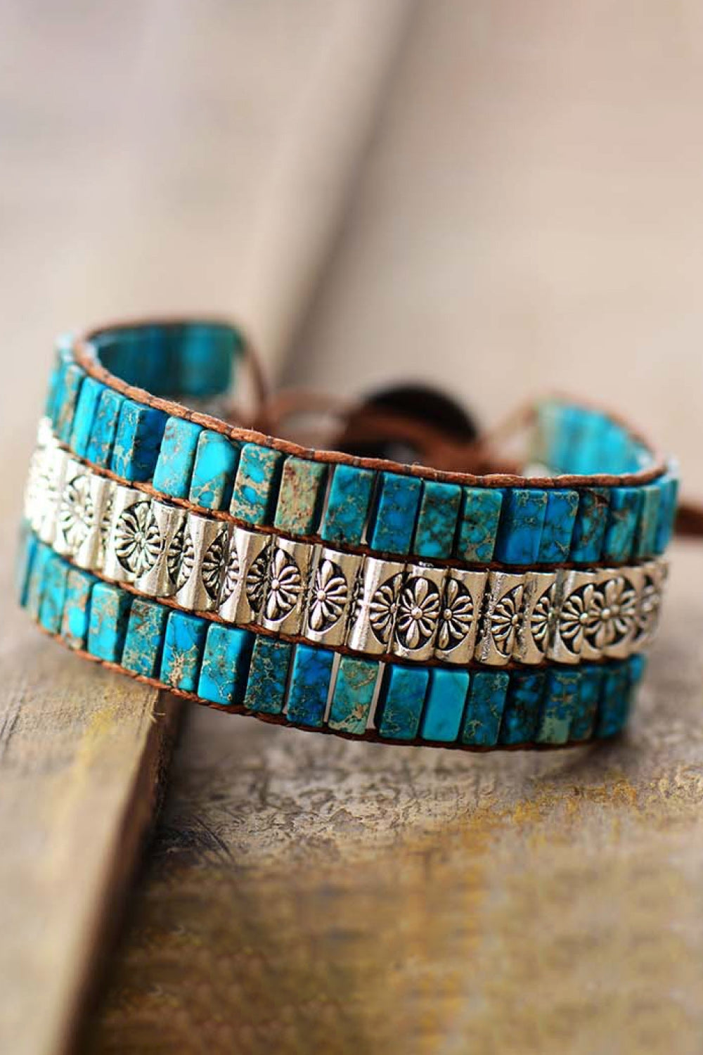 Turquoise tile and floral accent bracelet with leather cord.
