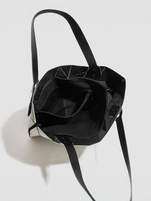 Silver handbag featuring glossy finish and geometric