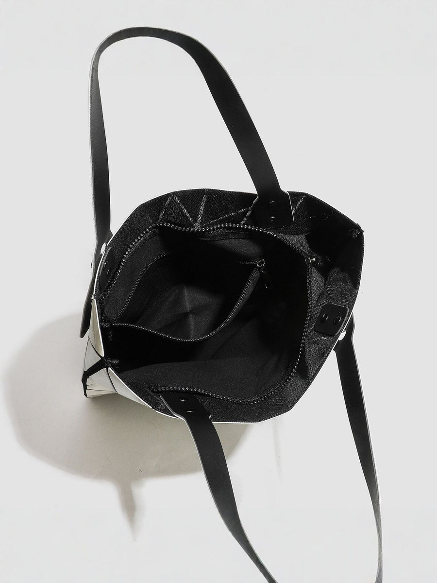 Silver handbag featuring glossy finish and geometric