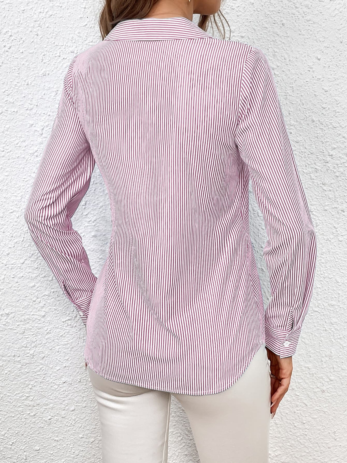 Blush pink and white striped wrap blouse with button cuffs and a collared neckline.