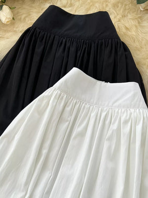 Black and white high-waisted skirts with gathered waist detail and pockets.