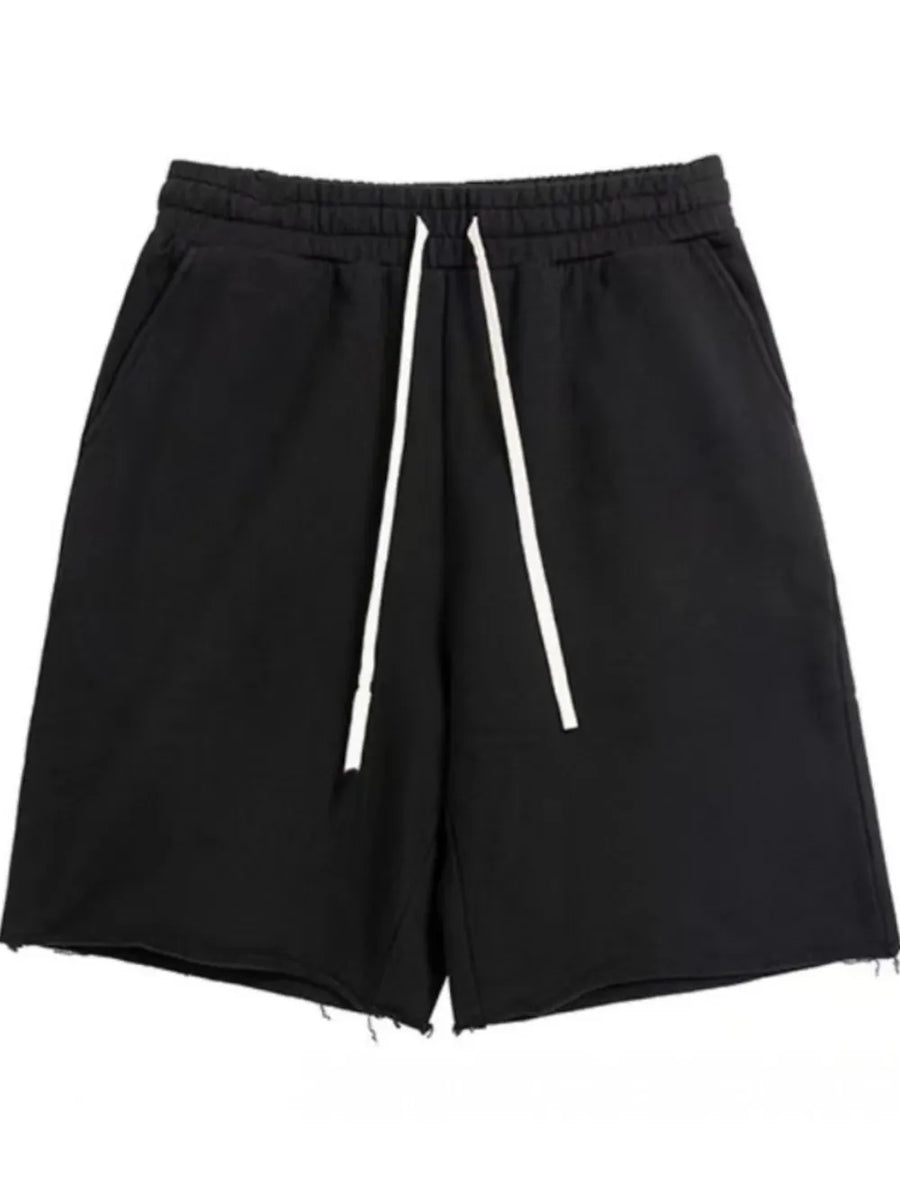 Black relaxed fit jogger shorts with raw hem and white drawstring.