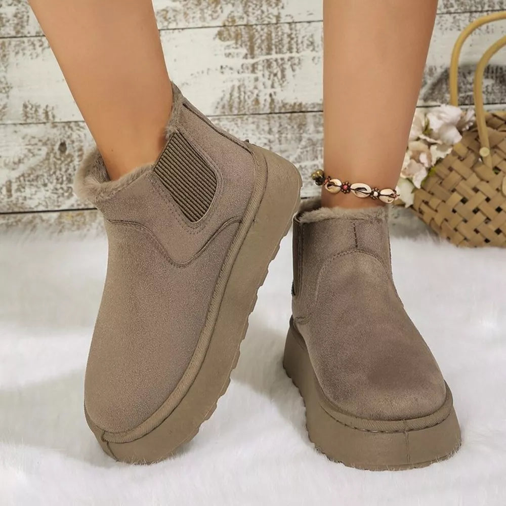 Caramel suede round toe platform ankle boots with faux fur lining and elastic gore.