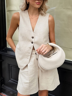 Buttoned vest and shorts set in beige cotton, featuring a V-neck vest and tailored shorts.