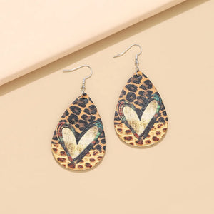 Leopard print teardrop earrings with a distressed heart detail and silver hooks.