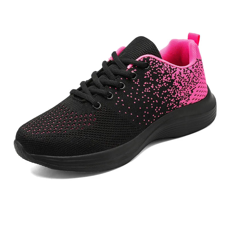 Black knit athletic shoe with pink gradient detail and black sole.