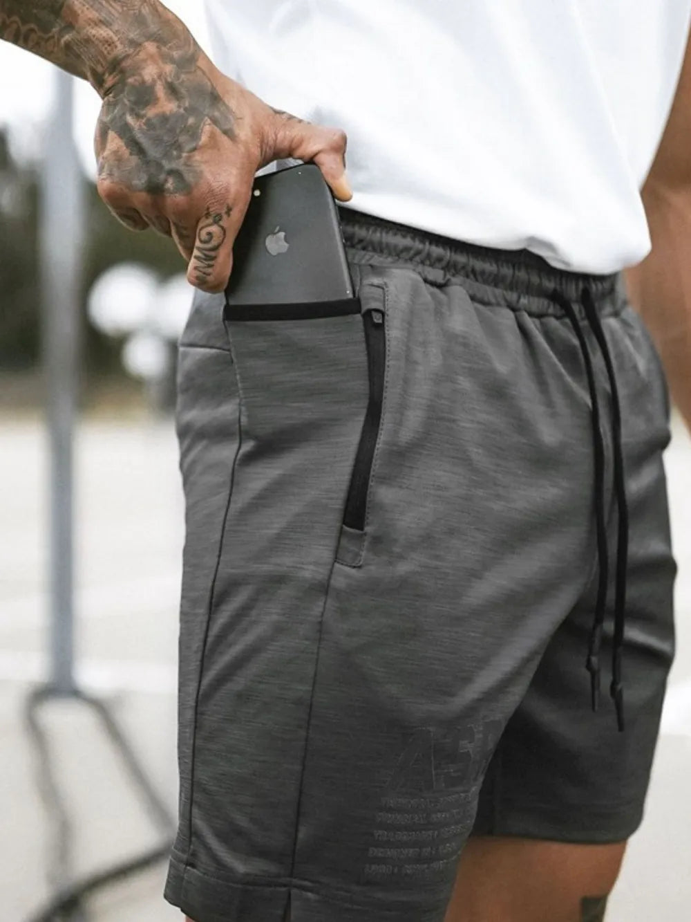 Dark Gray Tech-Knit Utility Pocket Shorts with zipper pocket detail and drawstring waist.