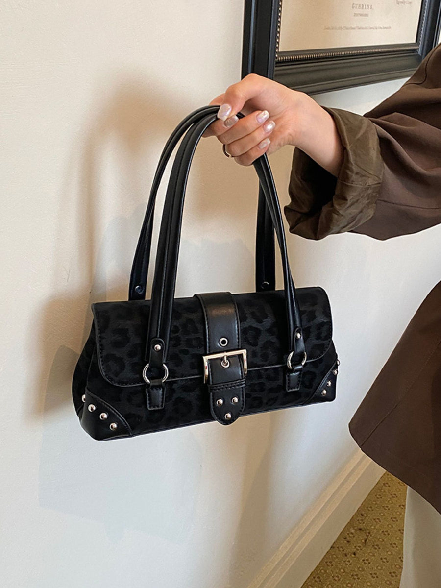Pink shoulder bag featuring buckle detail and leopard