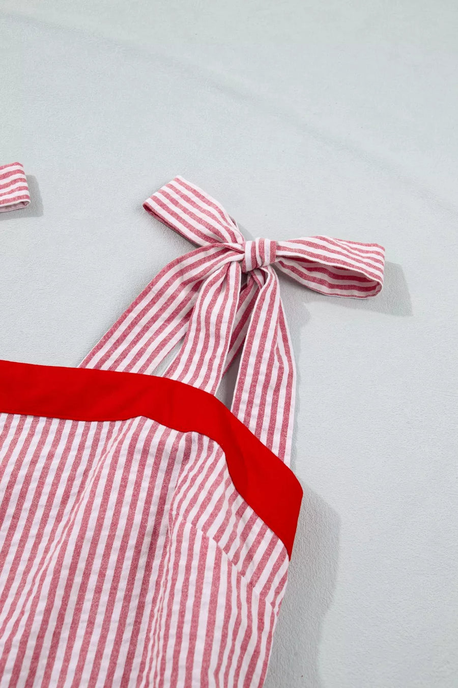 Maxi dress with red and white stripes, red trim, and bow knot shoulder straps.
