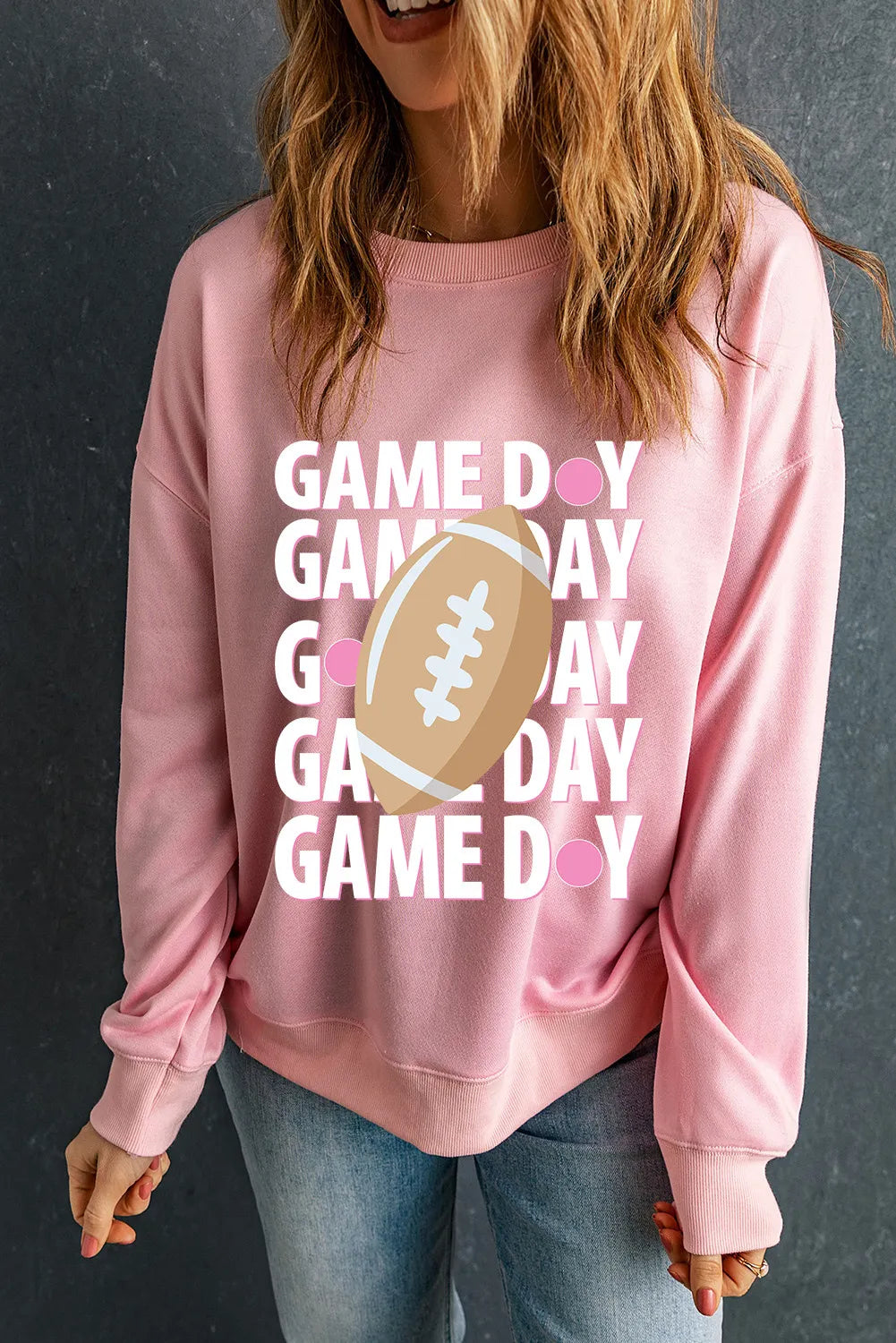 Blush pink ribbed long sleeve sweatshirt with "Game Day" text and football graphic