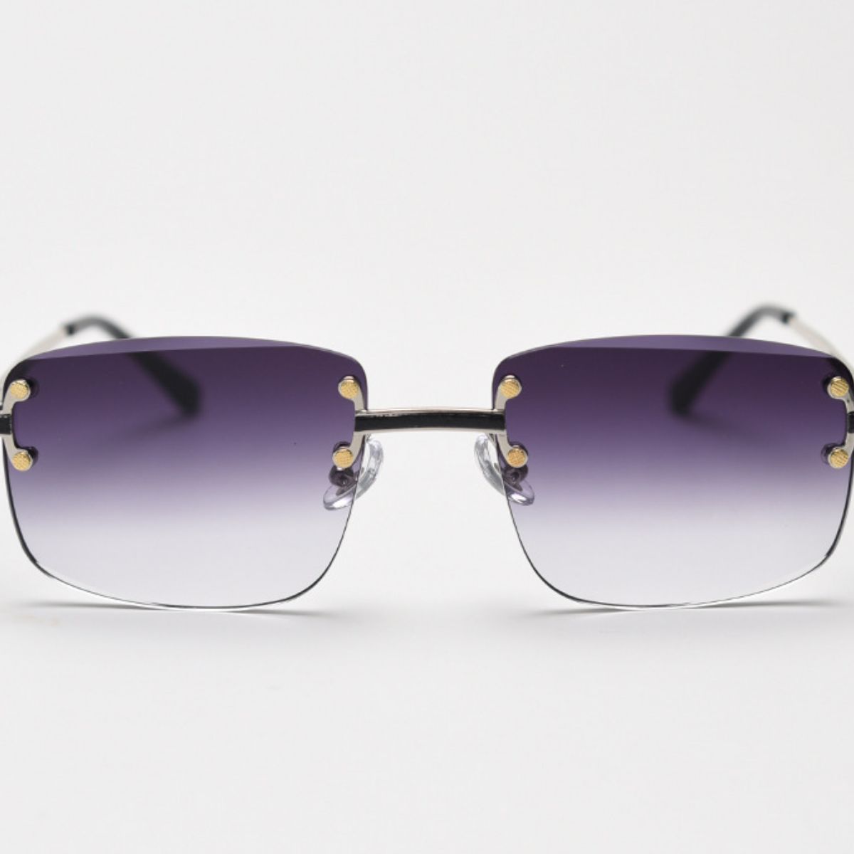 Rimless gradient tinted sunglasses with purple to clear lenses and gold accents.