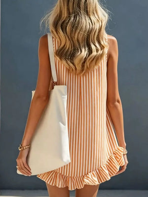 Vibrant striped mini dress with V-neck and ruffled hem, worn with a tote bag.