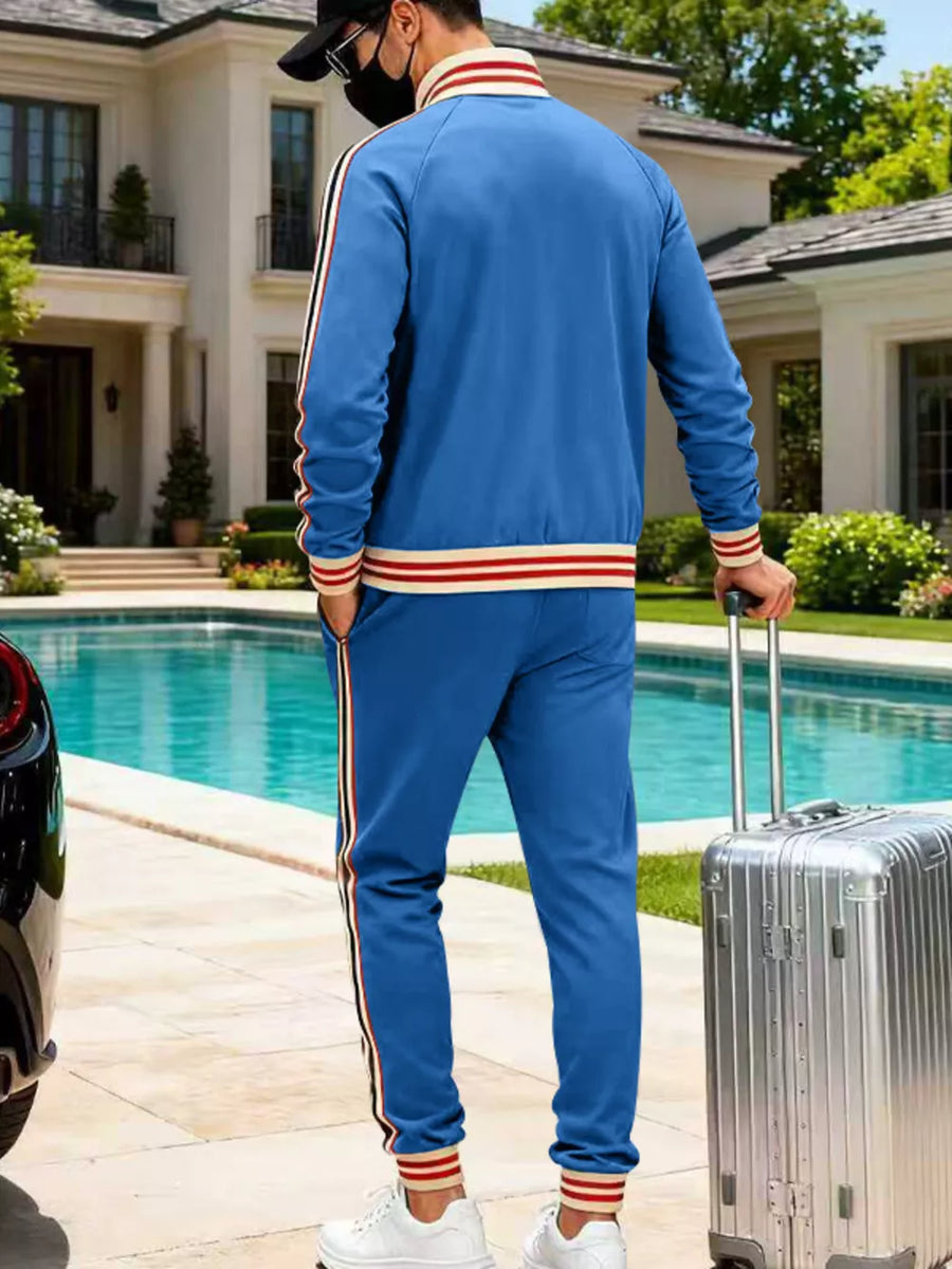 Men's French blue tracksuit with red and white striped sleeves and cuffs.