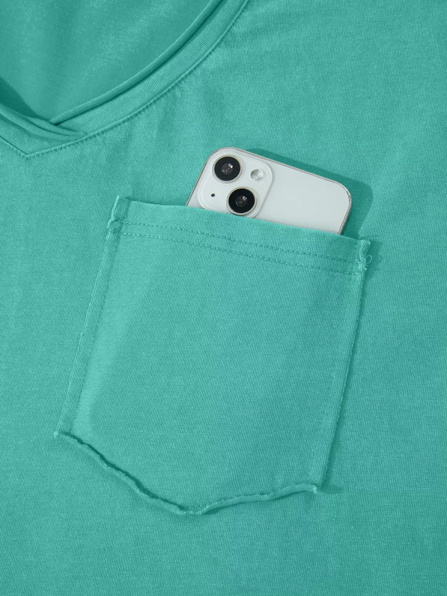 Teal mineral wash cotton tee with V-neck and chest pocket holding a smartphone.