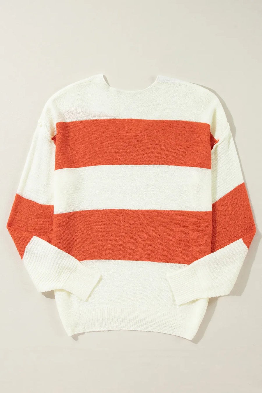 Orange and white striped V-neck knit sweater with a slouchy fit