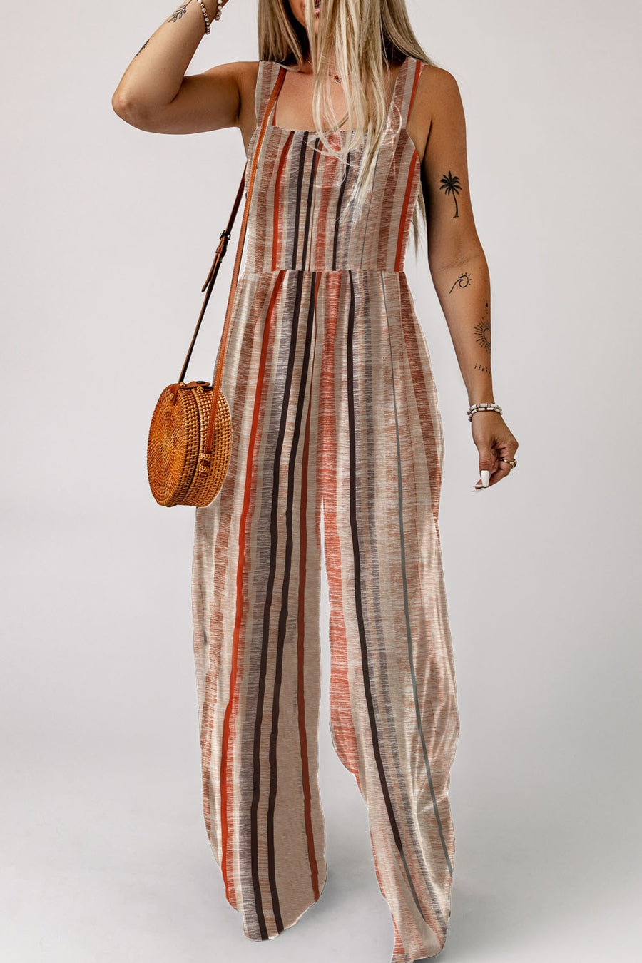 Striped square neck wide-leg romper with adjustable straps and a cinched waist.
