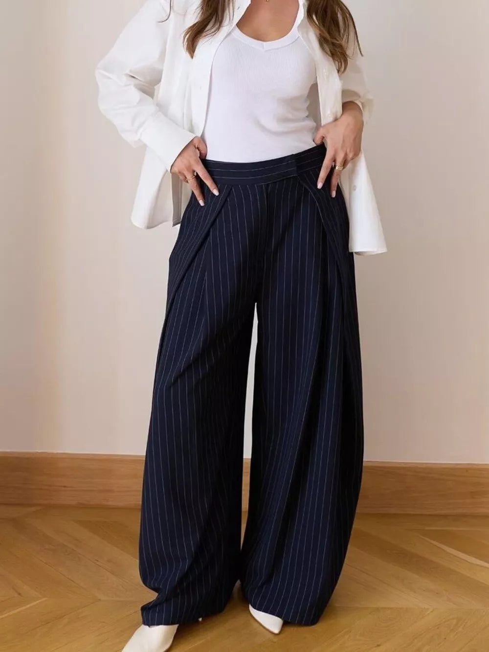 Wide-leg pants in dark blue with white pinstripes, featuring a high waist and flowing silhouette.