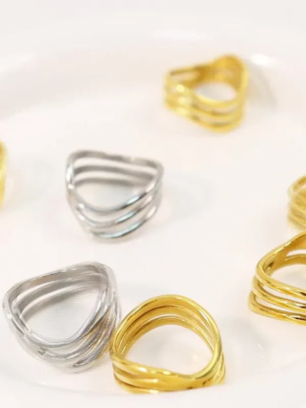 Triple-band sculptural ring in gold and silver, 18K gold-plated bands.