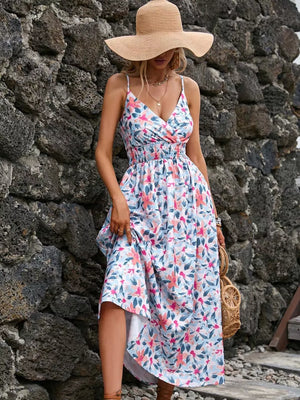 Maxi dress with floral print, V-neck, spaghetti straps, smocked waist, and tiered skirt.