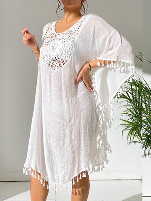 White crochet yoke kaftan dress with tassel trim and wide sleeves.