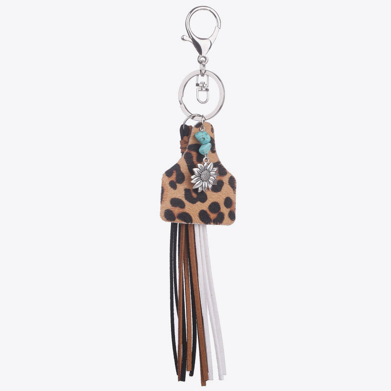 Leopard print tag keychain with flower charm, turquoise bead, and multi-color tassels.