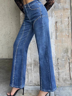 Studded high-waisted wide-leg jeans in blue denim with silver stud detailing.