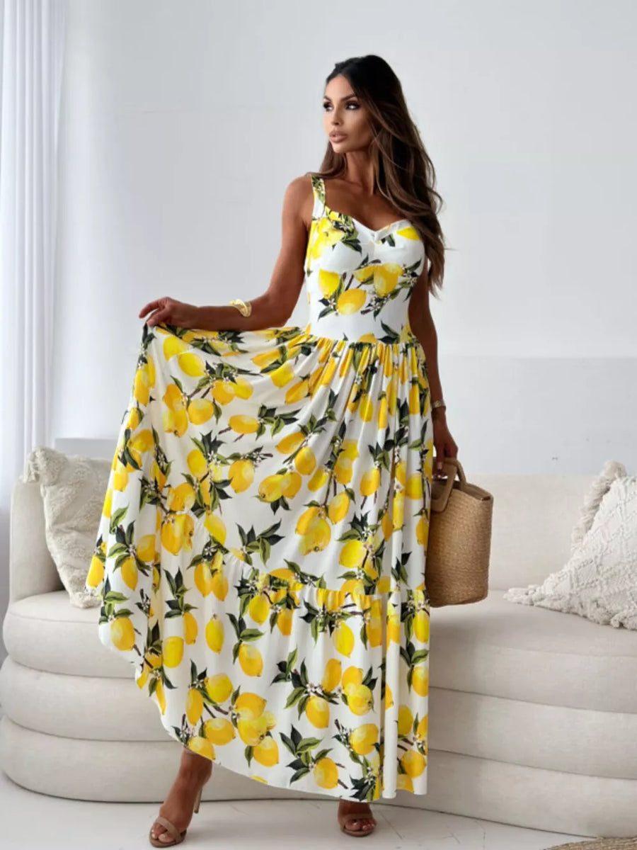 Lemon Blossom tiered maxi dress with sweetheart neckline and spaghetti straps, featuring a vibrant lemon print on white