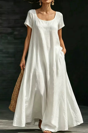 White polyester maxi dress with short sleeves, scoop neck, and pockets.