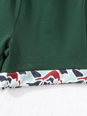 Dark green baby polo and shorts set with camouflage trim detail